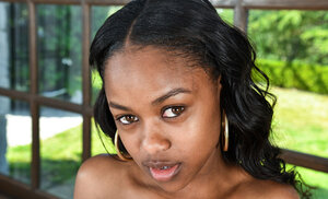 Black gal Amiliah Kush exposes petite boobs and then gets completely nude