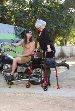 Grey-haired grown-up woman with glasses gets naked trying to lure young biker