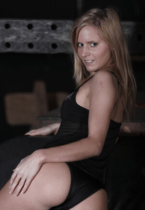 Seducing blonde Kandi seductively poses undressed in darkened living room