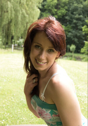 Redhead loves relaxing on the grass without clothes on her slim body