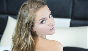 Undersized Russian kitten with small tits and nice butt poses naked in the bedroom