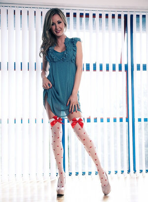 Lovely blond in high socks doffs clothes to flaunt her tempting assets