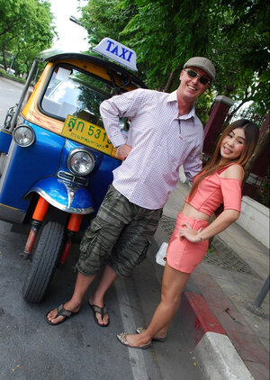 Joyful Thai minx poses near white fellow and besides his world-class auto rickshaw