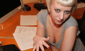 Bored secretary is posing for her colleague after her work is done