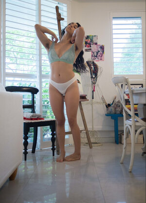 She is going to fix her hair and also show her flawless backside