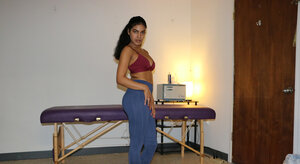 Sweet brunette masseuse offers an arousing handjob while topless