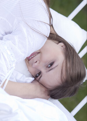 Beata Undine poses seductively on the outdoor day bed after stripping naked