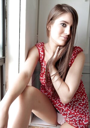 Engaging angel with long hair walks around apartment getting naked in the process