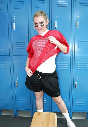 Lady football player prepares for game by posing naked in locker room